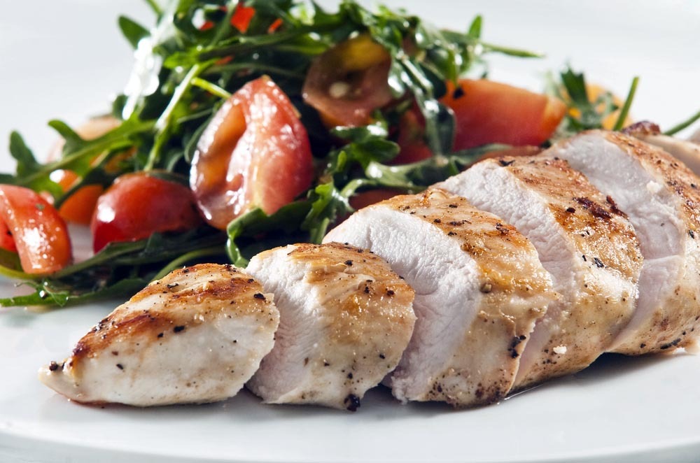 Grilled chicken breast served with salad